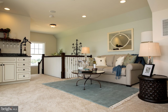 living room with light carpet and vaulted ceiling