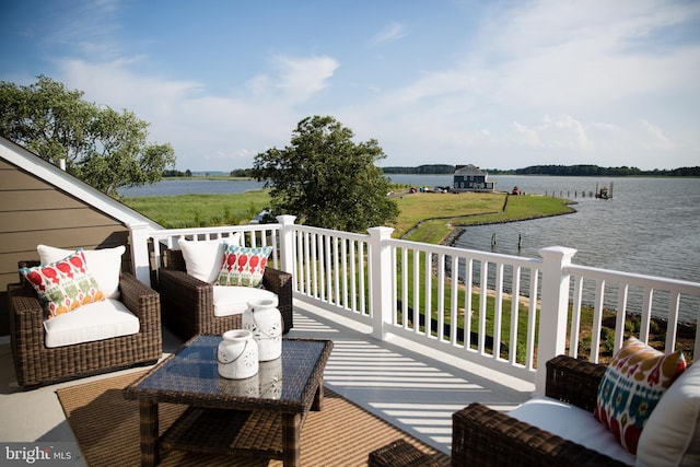 wooden terrace featuring a water view