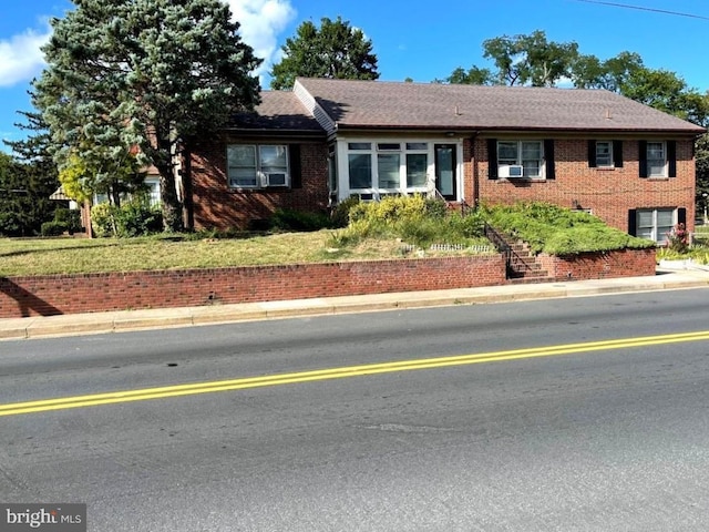 ranch-style house with cooling unit