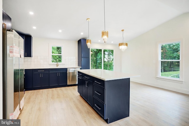 kitchen featuring dishwasher, light hardwood / wood-style flooring, backsplash, pendant lighting, and a kitchen island