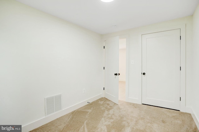 unfurnished bedroom with light carpet