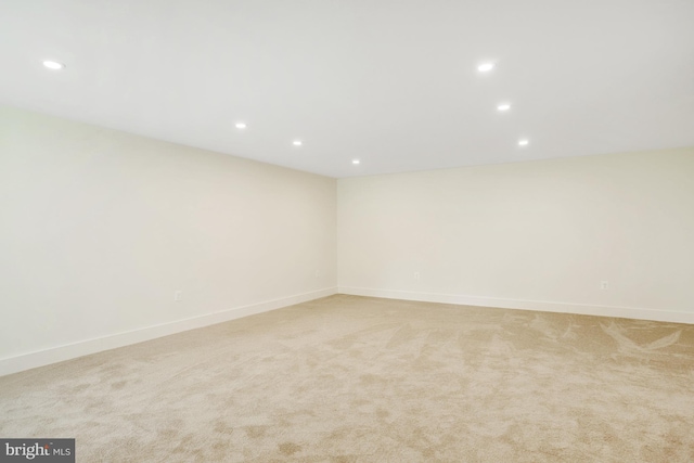 spare room featuring light colored carpet