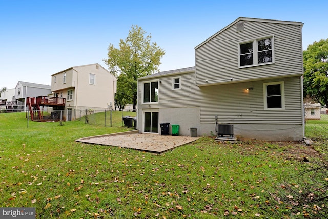 back of property featuring a lawn, cooling unit, and a patio