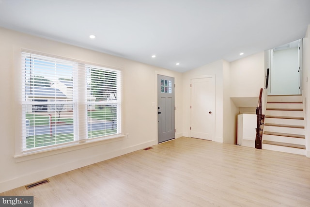 entryway featuring light hardwood / wood-style floors and lofted ceiling