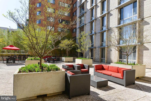 view of home's community featuring an outdoor living space and a patio