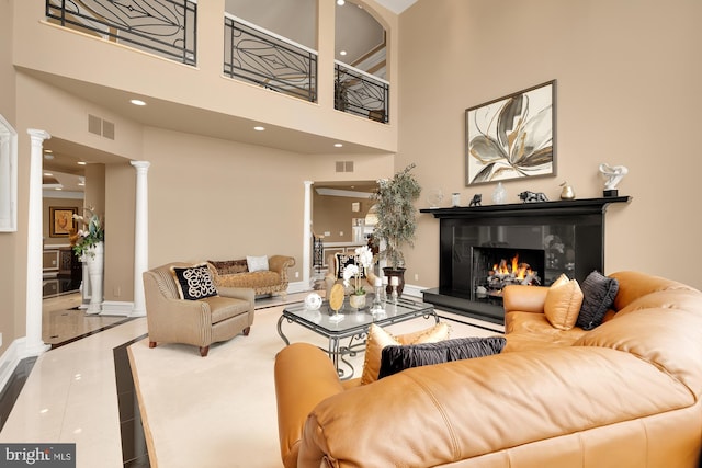 14950 Kelley Farm, Darnestown, MD 20874 - tiled living room with ornate columns, a lit fireplace, a towering ceiling, inlaid floor details, and recessed lighting