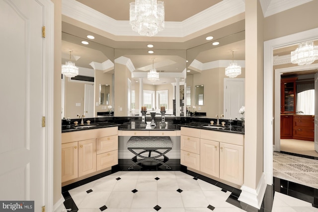 bathroom with tile patterned flooring, vanity, and an inviting chandelier