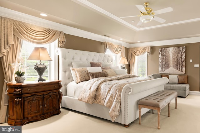 bedroom with a tray ceiling, ceiling fan, carpet flooring, and ornamental molding