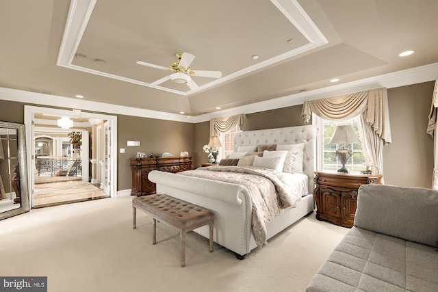 bedroom with access to outside, carpet flooring, ceiling fan, ornamental molding, and a tray ceiling