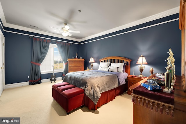 carpeted bedroom featuring ceiling fan and crown molding