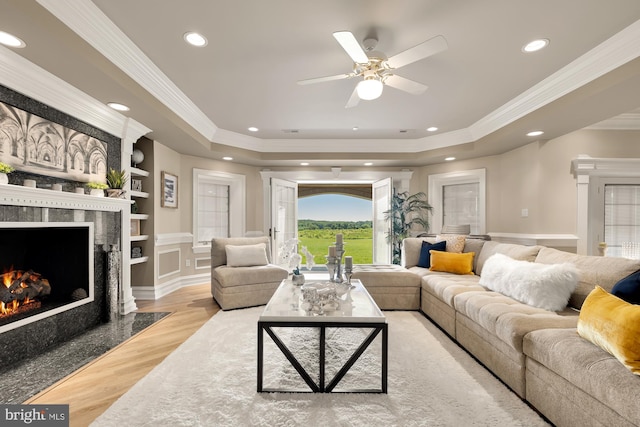 14950 Kelley Farm, Darnestown, MD 20874 - living area featuring a raised ceiling, wood finished floors, crown molding, built in features, and a premium fireplace