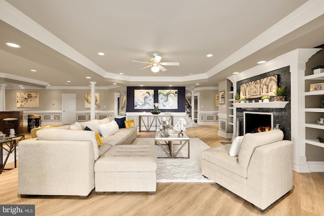14950 Kelley Farm, Darnestown, MD 20874 - living area featuring decorative columns, a tray ceiling, a high end fireplace, ceiling fan, and a decorative wall