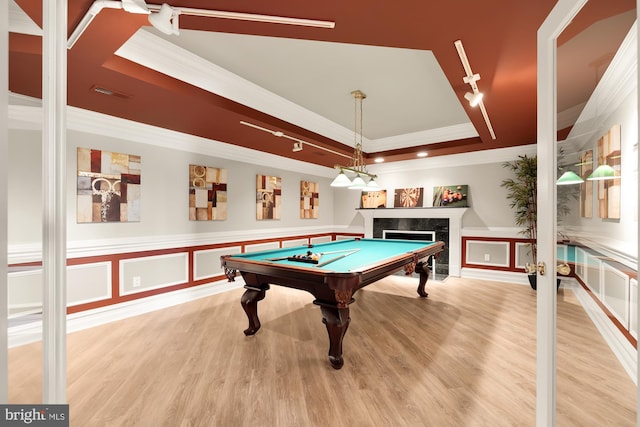 game room with hardwood / wood-style floors, crown molding, billiards, a fireplace, and a tray ceiling