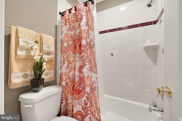 bathroom featuring shower / bath combination with curtain and toilet