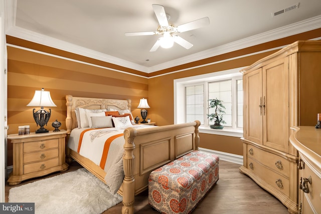 bedroom with ceiling fan, ornamental molding, and hardwood / wood-style flooring