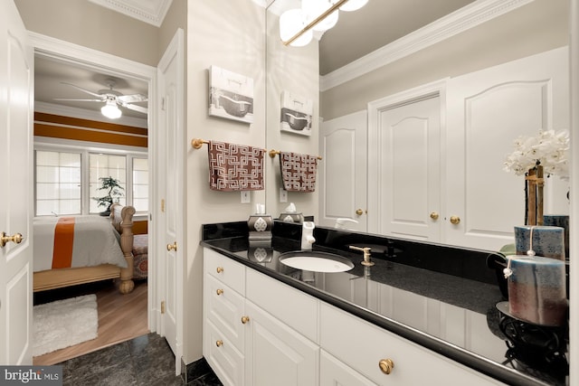 bathroom with ceiling fan, vanity, and ornamental molding