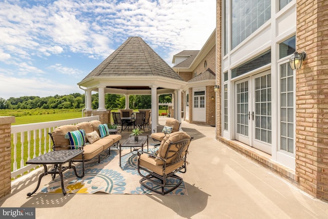 view of patio / terrace with a gazebo, an outdoor living space, and french doors