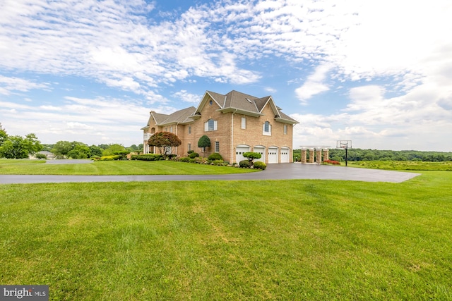 view of front of property featuring a front lawn and a garage