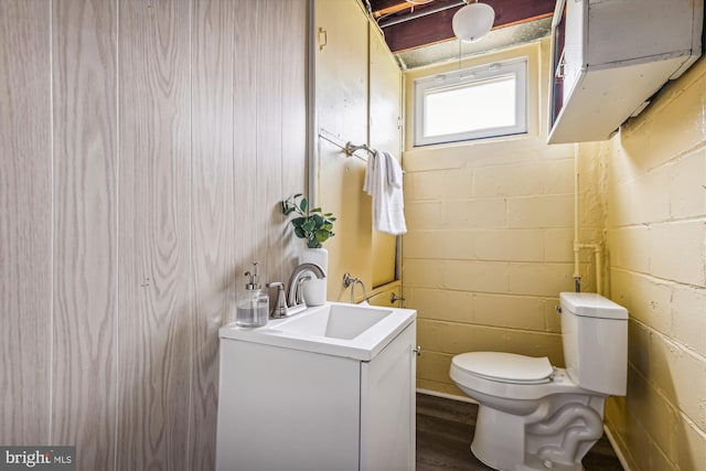 bathroom with hardwood / wood-style floors, vanity, and toilet