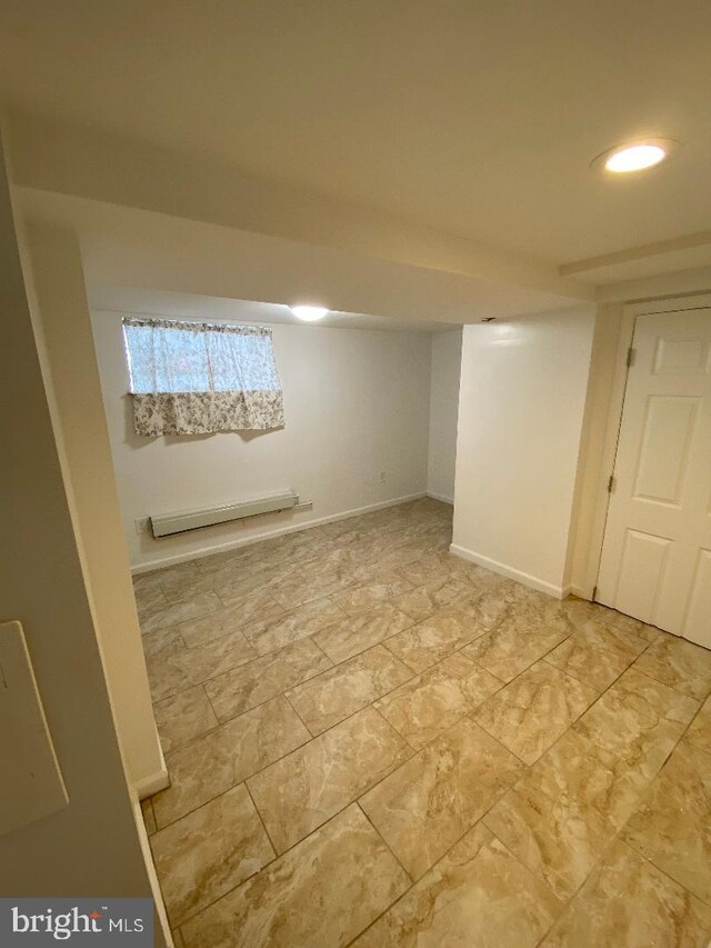 empty room with wood-type flooring, radiator heating unit, and a healthy amount of sunlight