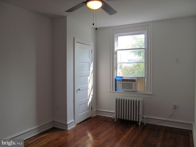 unfurnished bedroom featuring hardwood / wood-style floors, ceiling fan, radiator heating unit, and cooling unit