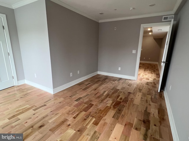 empty room with light hardwood / wood-style flooring and ornamental molding