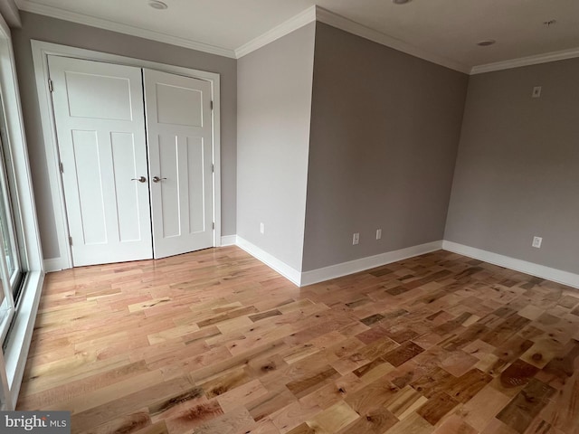 unfurnished room featuring light hardwood / wood-style floors and crown molding