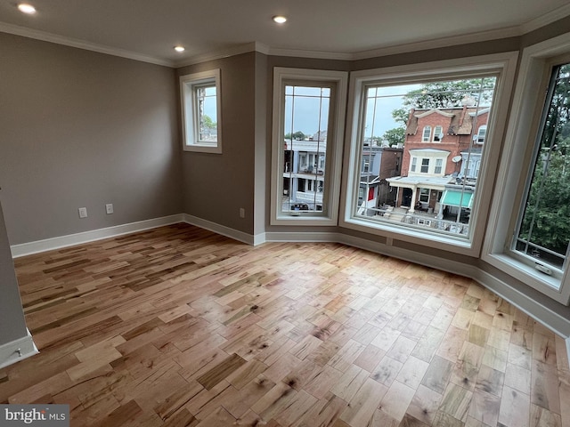 unfurnished dining area featuring plenty of natural light, light hardwood / wood-style floors, and crown molding