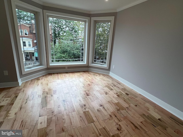 unfurnished room featuring light hardwood / wood-style flooring and ornamental molding