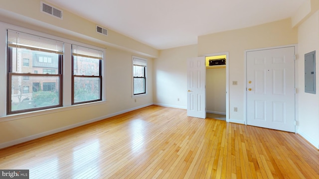 spare room with light wood-type flooring and electric panel