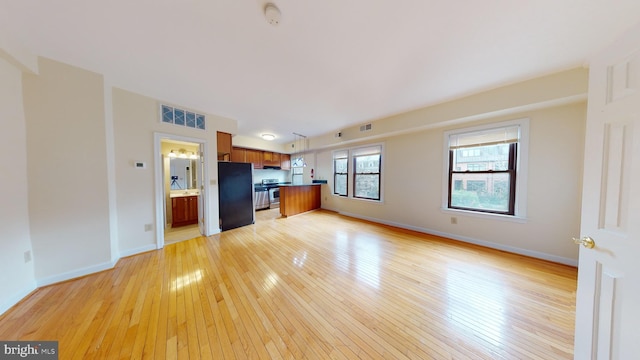 unfurnished living room featuring light wood-type flooring