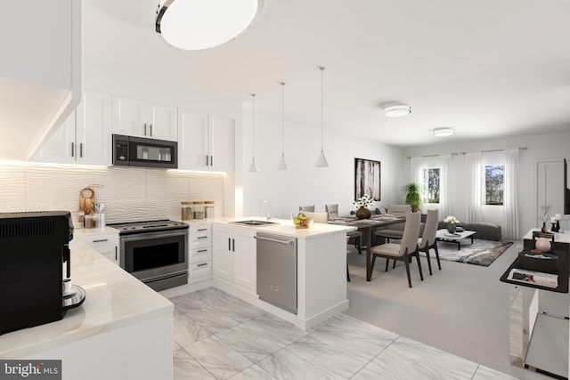 kitchen with kitchen peninsula, stainless steel appliances, sink, decorative light fixtures, and white cabinetry