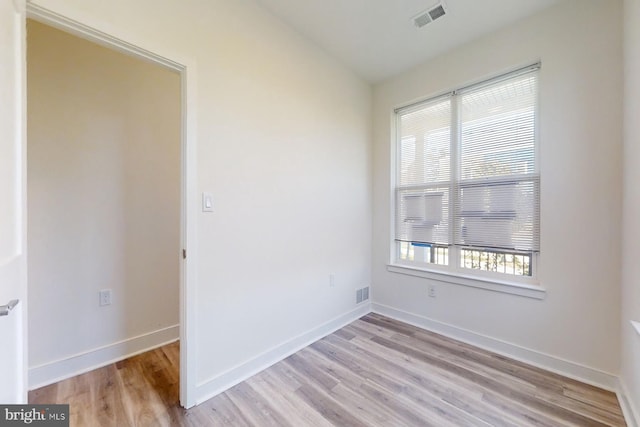 spare room featuring light hardwood / wood-style flooring