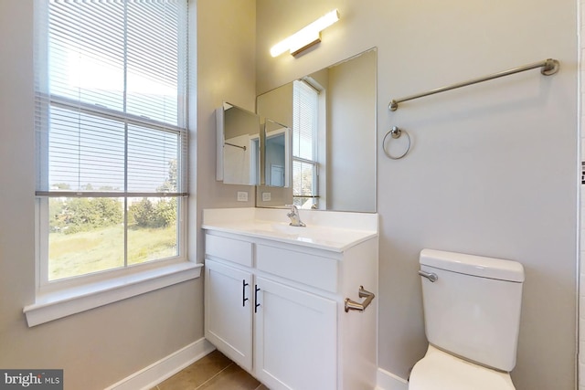 bathroom with tile patterned flooring, vanity, and toilet