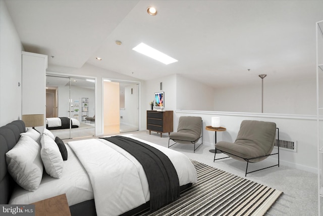 bedroom featuring light carpet, vaulted ceiling, and a closet