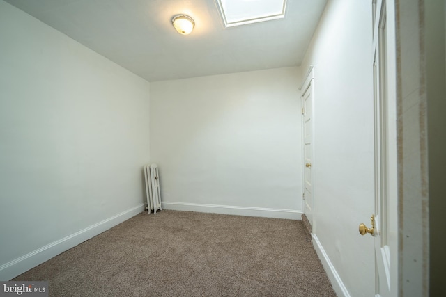 spare room featuring baseboards and carpet