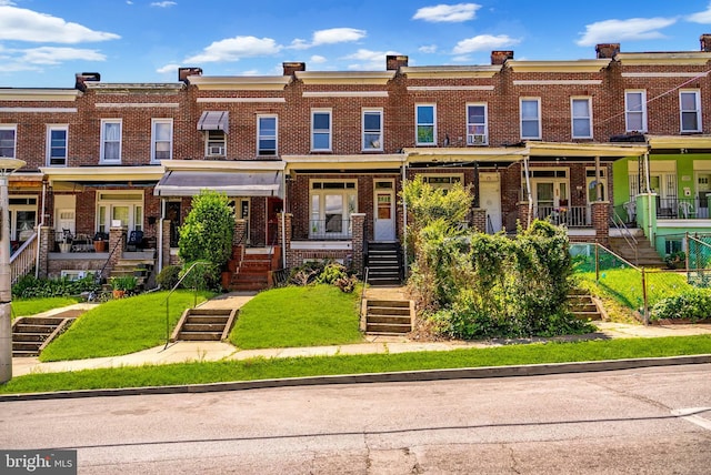 townhome / multi-family property featuring brick siding