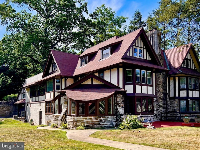 english style home with a front yard