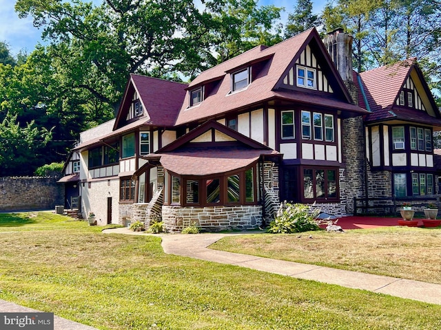 tudor house featuring a front lawn