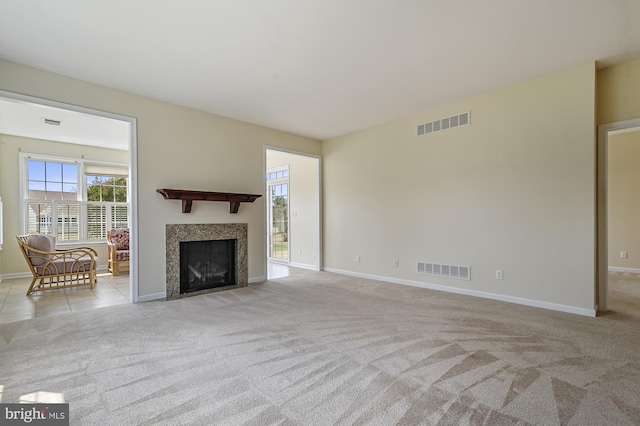 unfurnished living room featuring light colored carpet