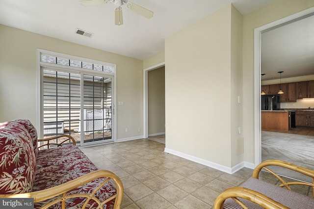 tiled living room featuring ceiling fan