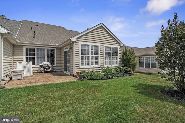 back of house with a yard and a patio area