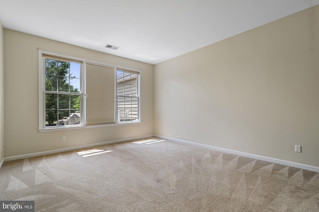 carpeted empty room featuring plenty of natural light