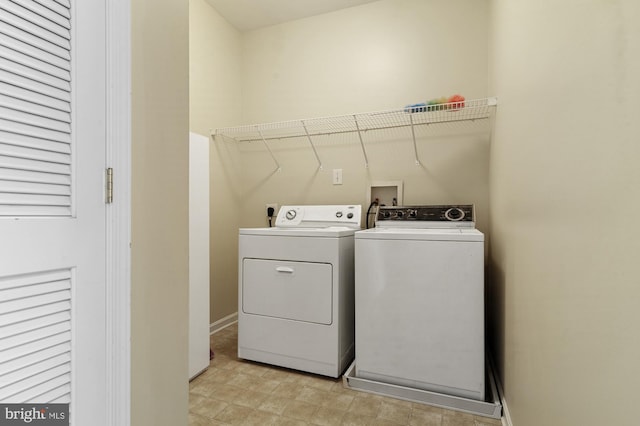 clothes washing area with separate washer and dryer