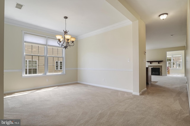 empty room with a notable chandelier, light colored carpet, and ornamental molding