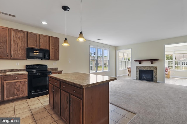 kitchen featuring a center island, light colored carpet, hanging light fixtures, and black appliances