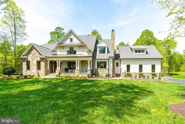 view of front facade with covered porch and a front yard