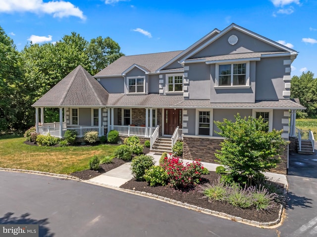 view of front of home featuring covered porch and a front yard