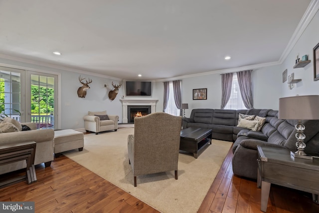 living room with light hardwood / wood-style flooring and ornamental molding