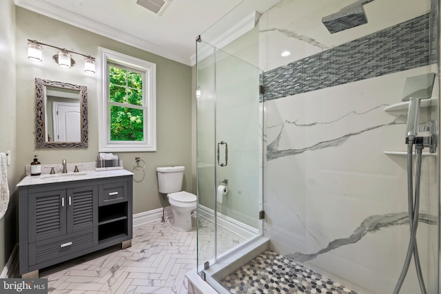 bathroom featuring vanity, toilet, a shower with door, and crown molding